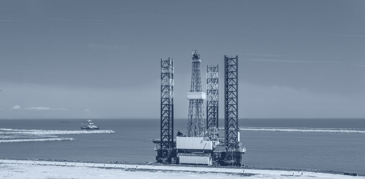 Jack-up drilling rig at a quayside.